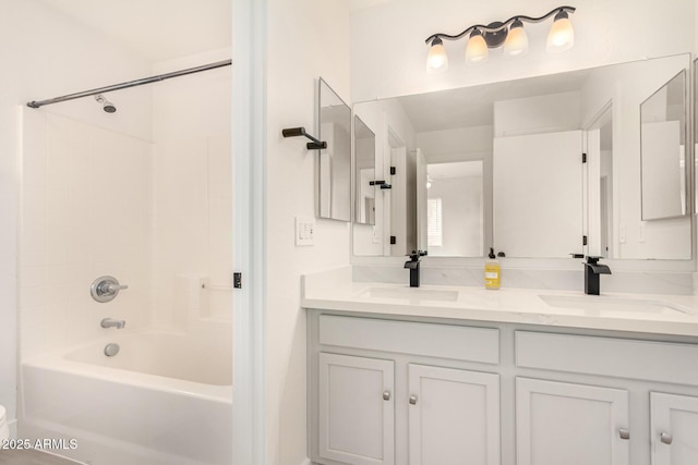 full bathroom featuring shower / bathtub combination, double vanity, and a sink