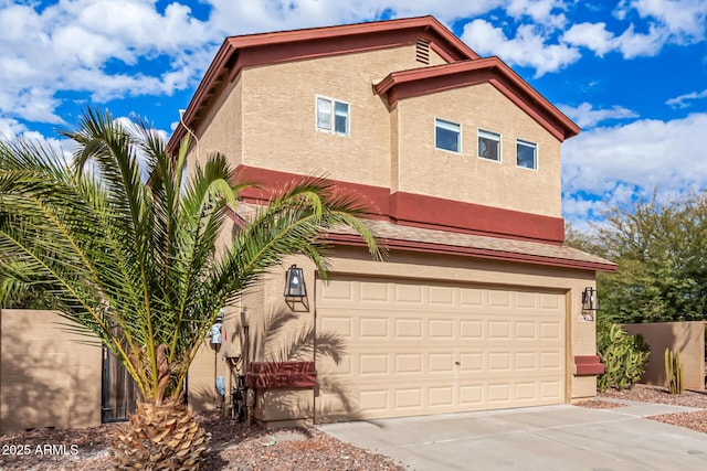 exterior space with driveway, an attached garage, and stucco siding