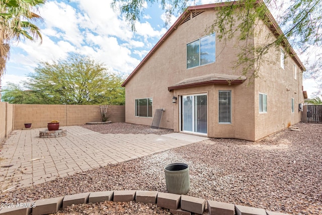 back of house with a patio area, a fenced backyard, and stucco siding