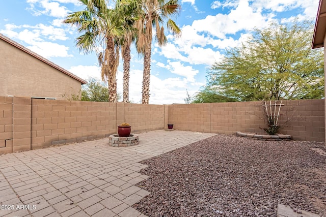 view of patio with an outdoor fire pit and a fenced backyard