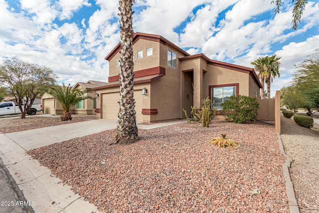 view of front facade featuring driveway, an attached garage, and stucco siding