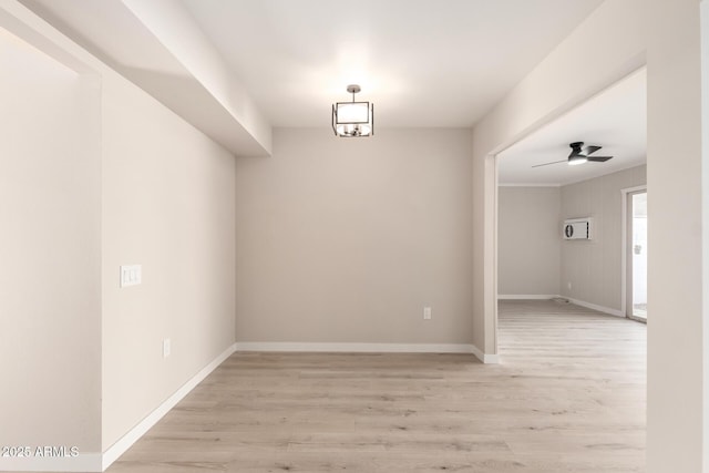 unfurnished dining area with baseboards, a ceiling fan, and light wood-type flooring