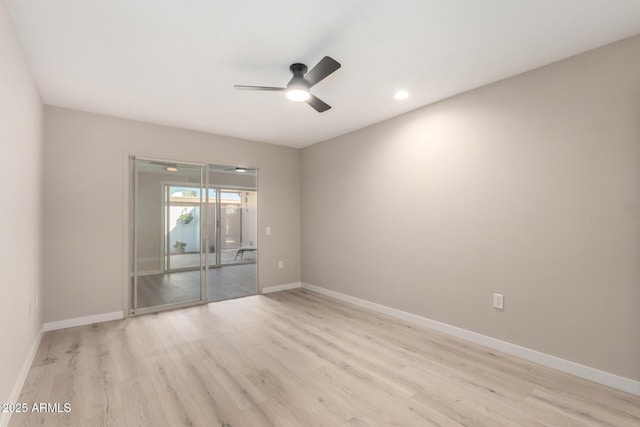 spare room featuring recessed lighting, light wood-type flooring, a ceiling fan, and baseboards