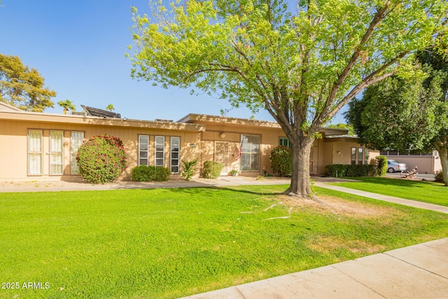 single story home with a front lawn and stucco siding