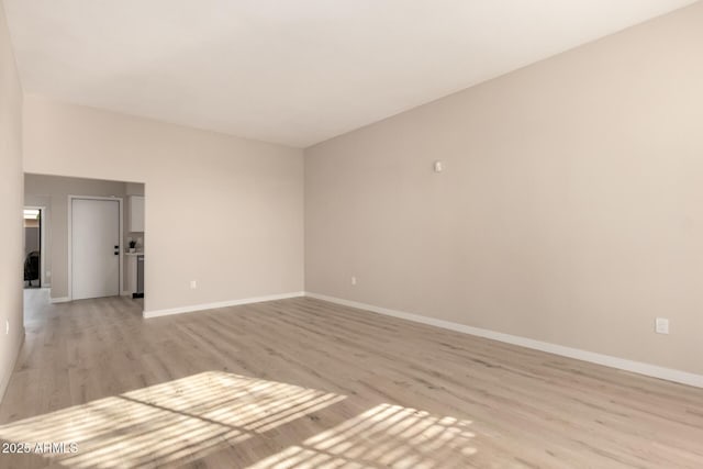 unfurnished room featuring light wood-style flooring and baseboards