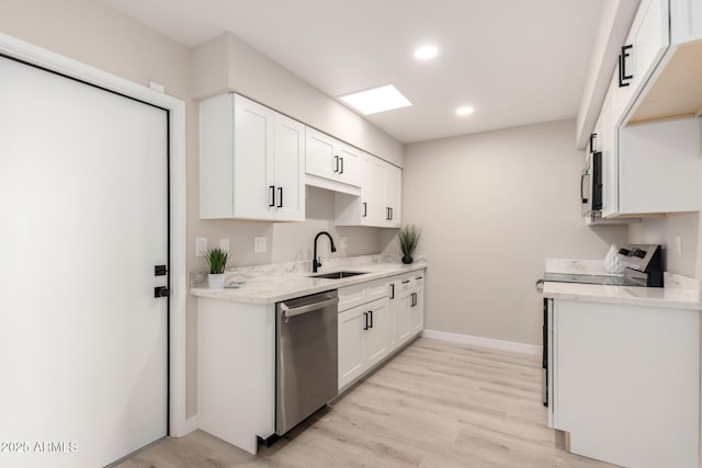 kitchen featuring light wood-type flooring, a sink, white cabinetry, and appliances with stainless steel finishes