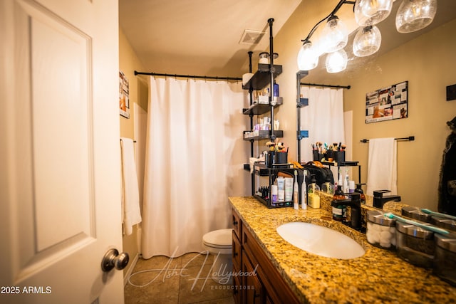 bathroom with vanity, tile patterned floors, and toilet