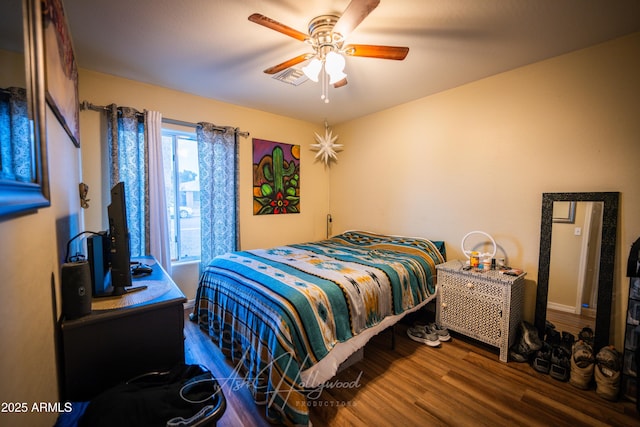 bedroom with dark wood-type flooring and ceiling fan