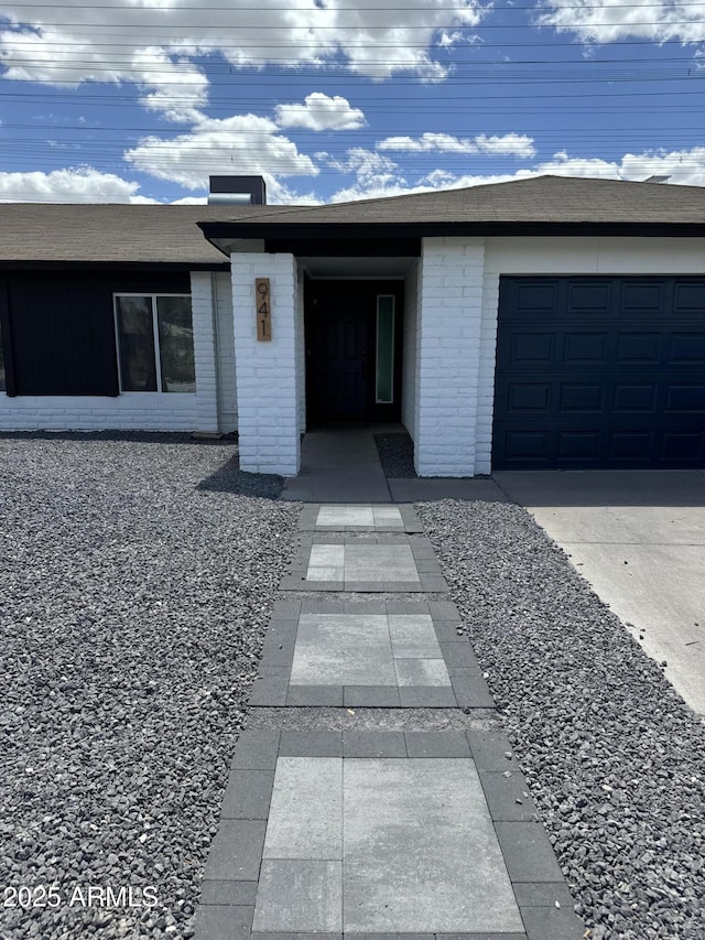 view of exterior entry featuring a garage