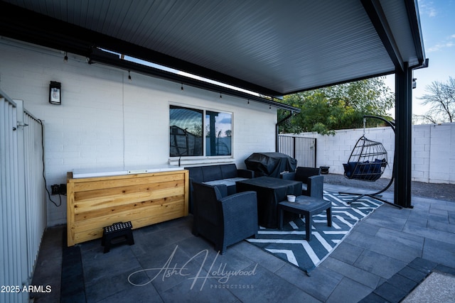 view of patio / terrace with area for grilling and an outdoor living space with a fire pit