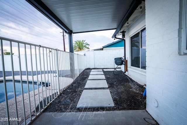 view of patio / terrace with a fenced in pool