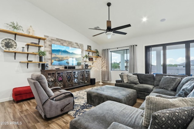 living room featuring lofted ceiling, light hardwood / wood-style floors, and ceiling fan