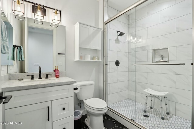 bathroom featuring vanity, toilet, and an enclosed shower