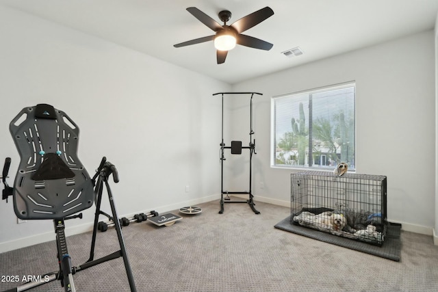 workout area with ceiling fan and carpet flooring