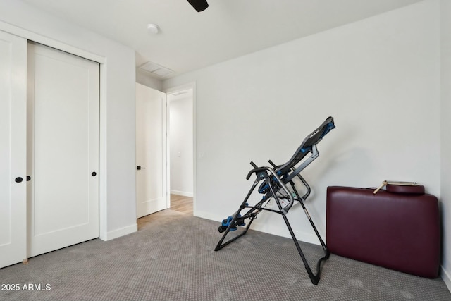 exercise area featuring light colored carpet