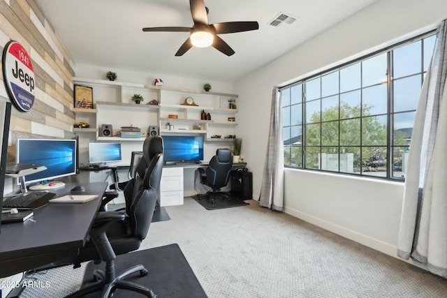 home office featuring light carpet and ceiling fan