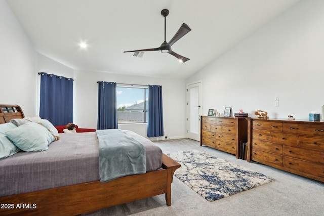 bedroom with ceiling fan, light colored carpet, and vaulted ceiling