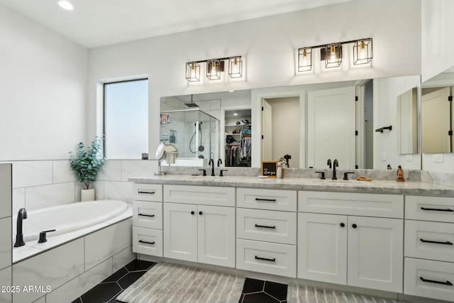 bathroom featuring tile patterned flooring, vanity, and separate shower and tub