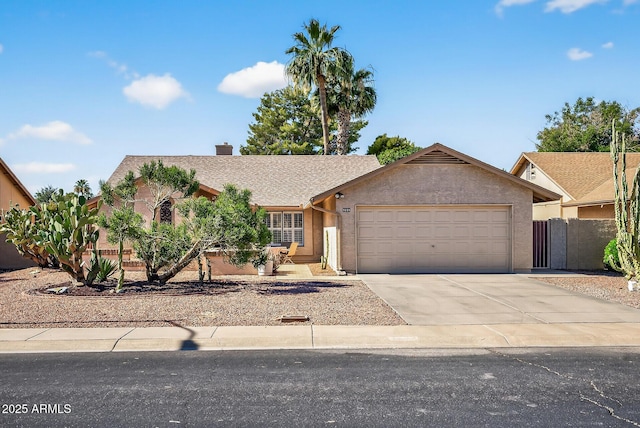 9839 W Utopia Rd, Peoria, AZ 85382 - view of front of property featuring a garage, concrete driveway, stucco siding, and a chimney