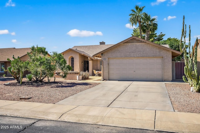 9839 W Utopia Rd, Peoria, AZ 85382 - view of front of home featuring stucco siding, driveway, a garage, and a chimney