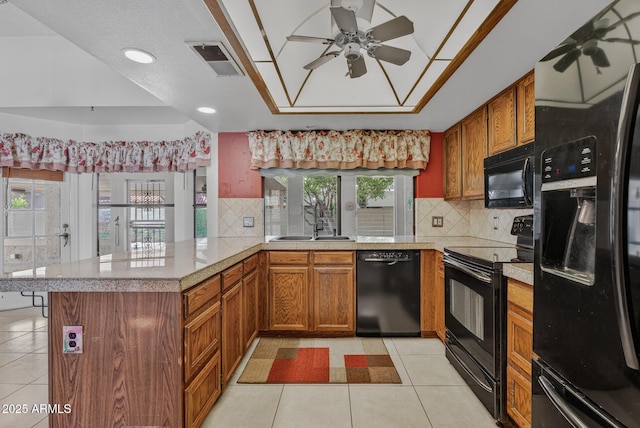 9839 W Utopia Rd, Peoria, AZ 85382 - kitchen featuring black appliances, ceiling fan, light countertops, a peninsula, and brown cabinetry