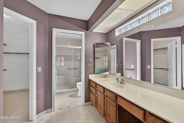9839 W Utopia Rd, Peoria, AZ 85382 - bathroom with a spacious closet, a stall shower, vanity, and tile patterned flooring