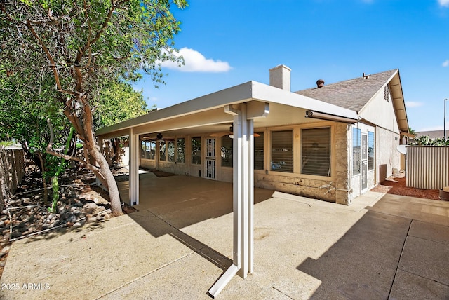 9839 W Utopia Rd, Peoria, AZ 85382 - back of property with a chimney, a shingled roof, and a patio