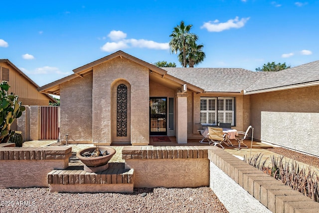 9839 W Utopia Rd, Peoria, AZ 85382 - back of property featuring a shingled roof, stucco siding, and a patio area