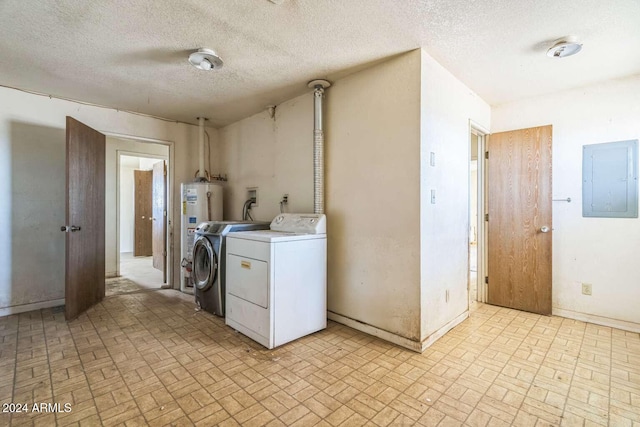 washroom featuring independent washer and dryer, a textured ceiling, and electric panel