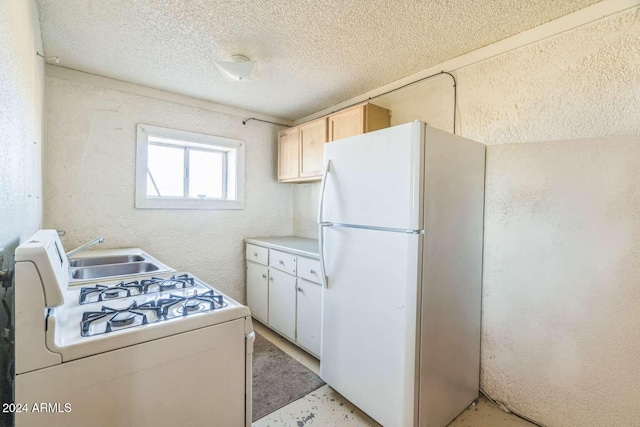 kitchen featuring a textured ceiling, white appliances, sink, and vaulted ceiling