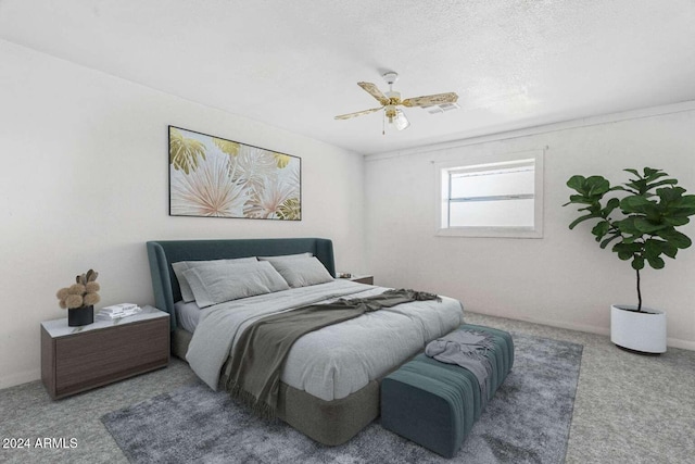 bedroom featuring carpet, a textured ceiling, and ceiling fan