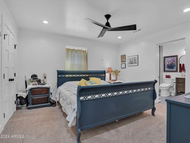 bedroom featuring carpet flooring, ensuite bath, and ceiling fan