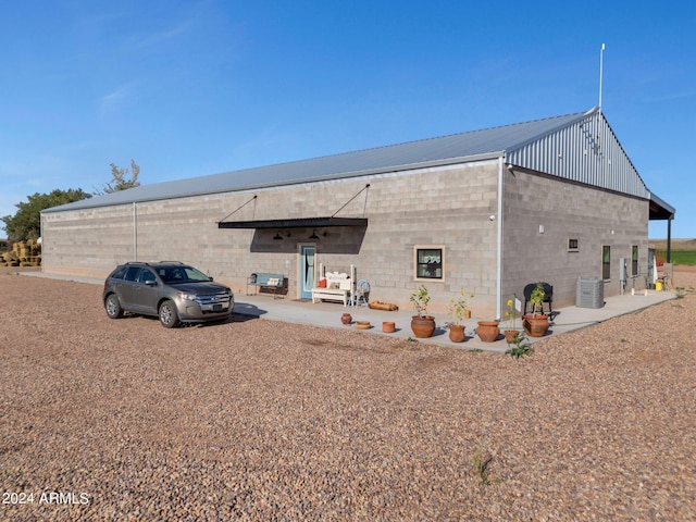 back of property featuring central air condition unit