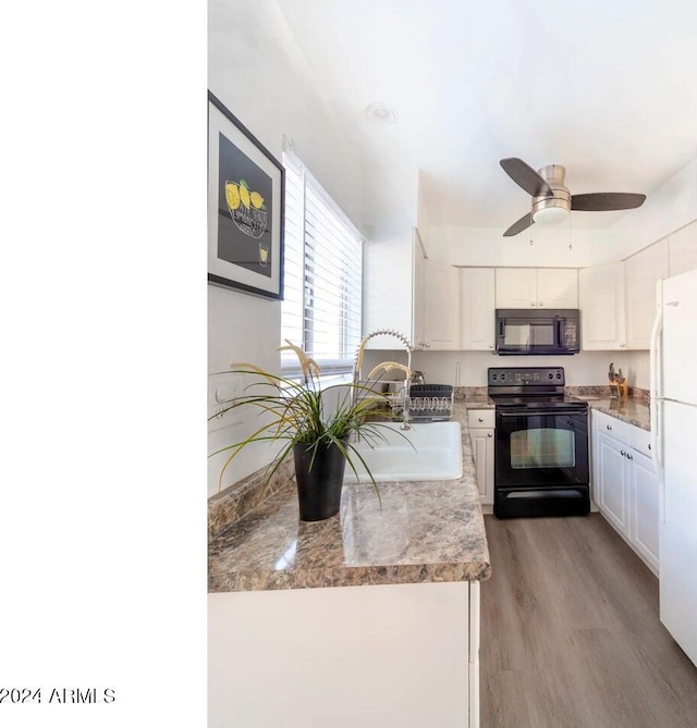 kitchen featuring ceiling fan, white cabinetry, black appliances, and light hardwood / wood-style flooring