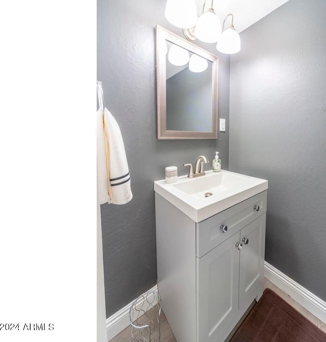 bathroom with vanity and a notable chandelier