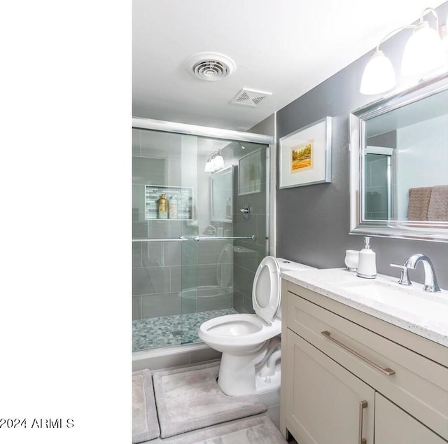 bathroom with walk in shower, vanity, tile patterned floors, and toilet