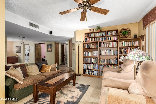 carpeted living room featuring a textured ceiling and ceiling fan