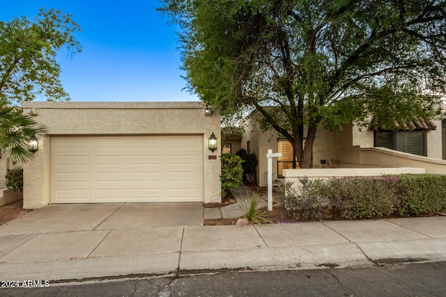 adobe home featuring a garage