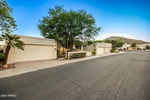 view of front of property featuring a mountain view and a garage