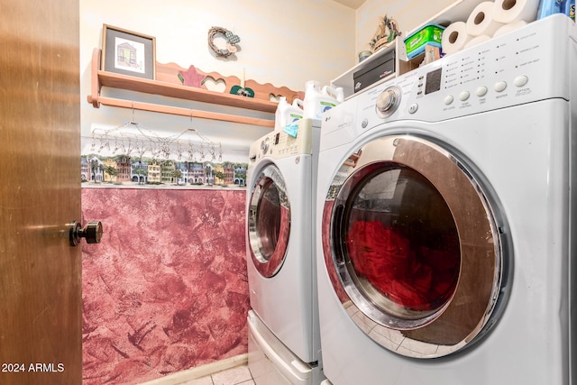 clothes washing area with light tile patterned flooring and washing machine and clothes dryer