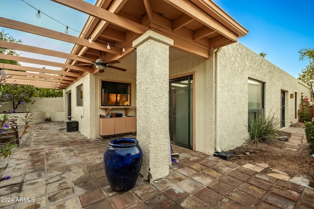 view of patio / terrace with ceiling fan and a pergola