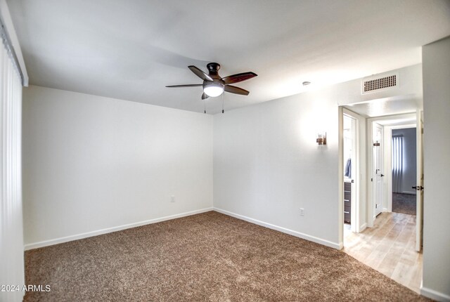 hall featuring light hardwood / wood-style floors and a textured ceiling