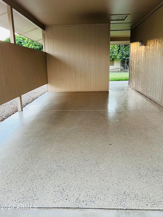 garage featuring wood walls