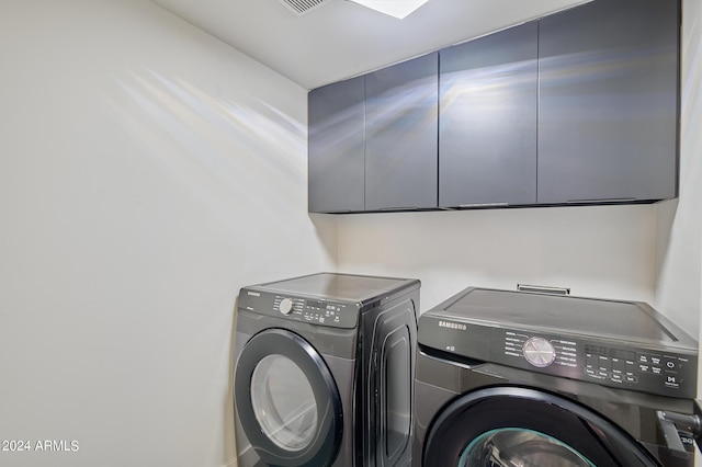 laundry area with cabinets and independent washer and dryer