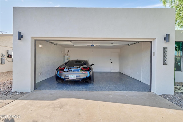 garage featuring a garage door opener and water heater