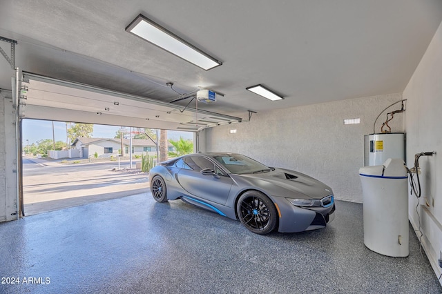 garage featuring a garage door opener and water heater