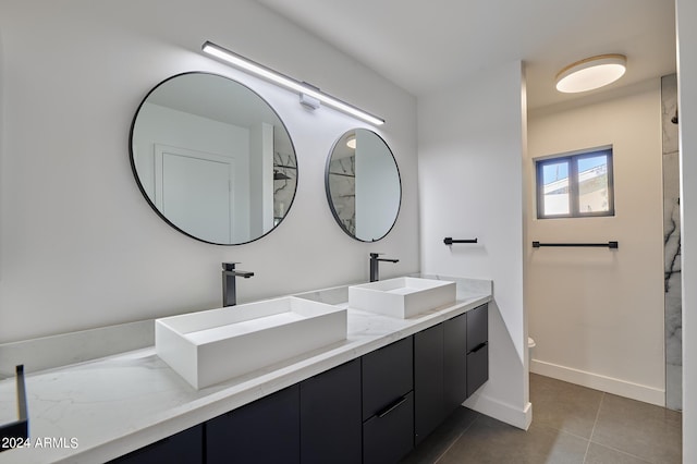 bathroom with vanity, toilet, and tile patterned flooring