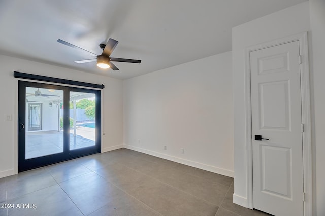 tiled empty room with french doors and ceiling fan