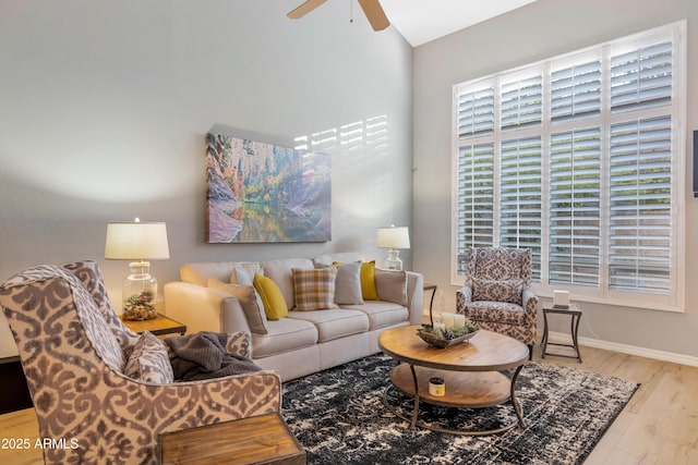 living room with light hardwood / wood-style flooring and ceiling fan