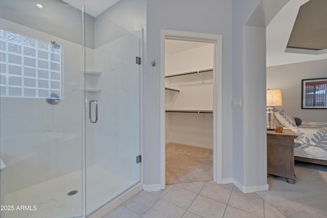 bathroom with tile patterned floors and an enclosed shower